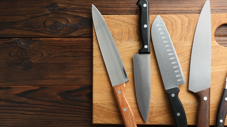 kitchen knives on wooden board