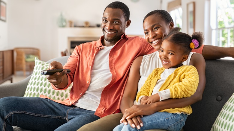 Parents and child watching television