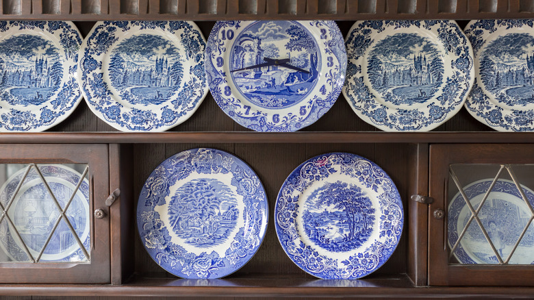 Blue decorative plates on shelves