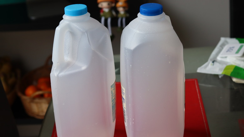 Two empty milk jugs