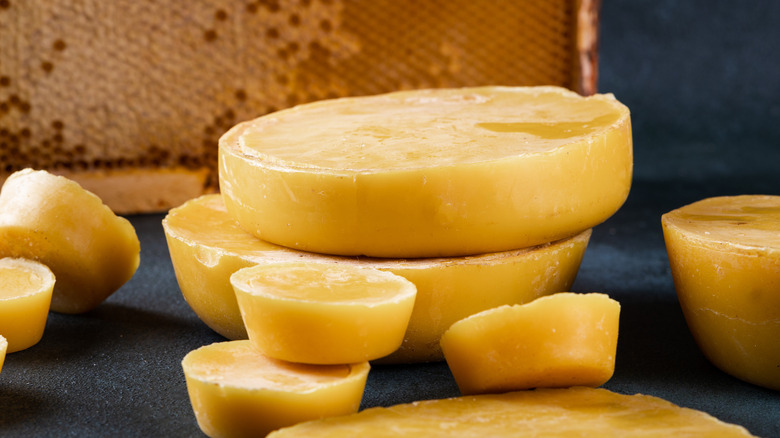 Mounds of beeswax with combs