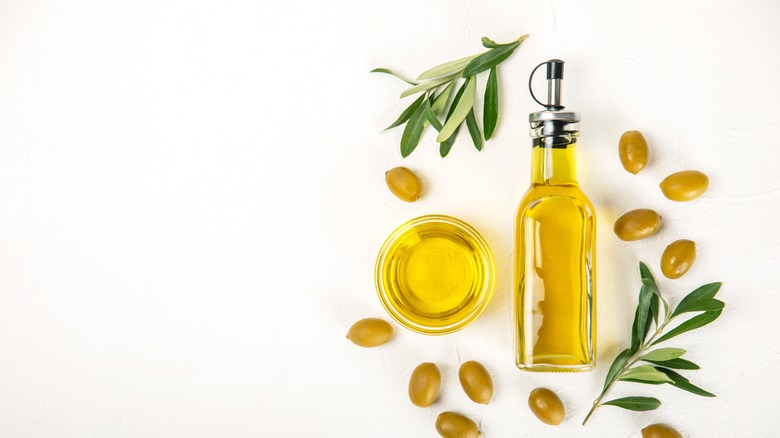 Bottle of olive oil and olive fruits