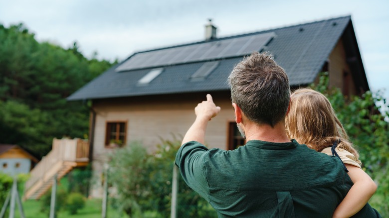 pointing at a family home