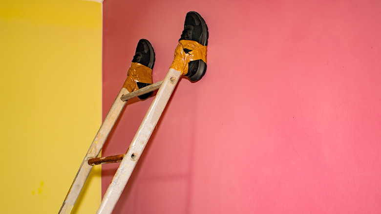 old sneakers taped to ladder