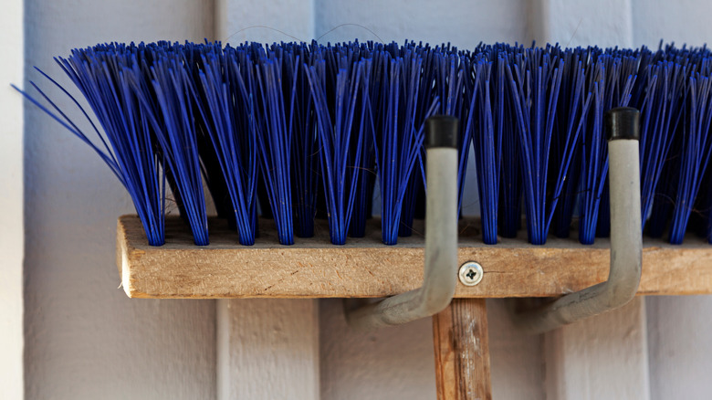 broom hanging on hook