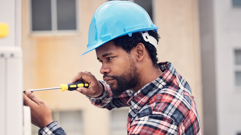 Man holding screwdriver