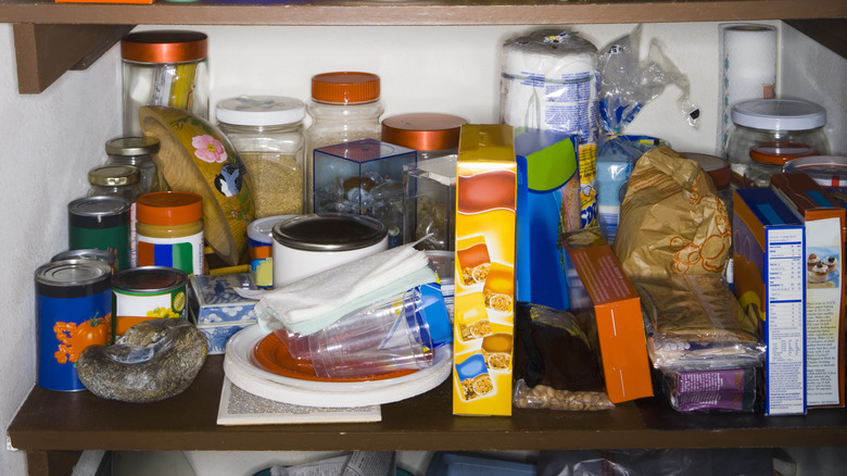 A messy kitchen cabinet