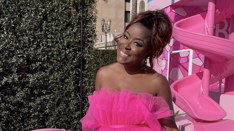 Tiffany Brooks in pink smiling