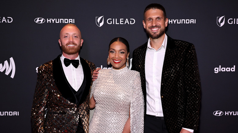 Keith Bynum, Shea Hicks Whitfield, and Evan Thomas smiling at a red carpet event