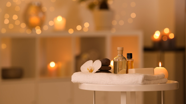 Spa supplies in candlelit bathroom