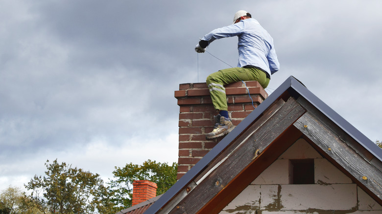 Man cleaning chimney