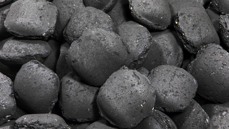 Charcoal briquettes are piled up