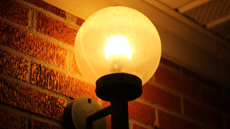 Illuminated yellow porch light 