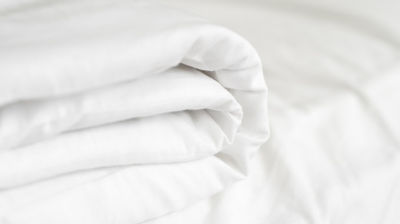 Folded bedsheets in white