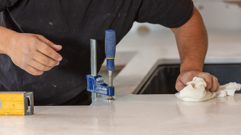 Man gluing countertop seam