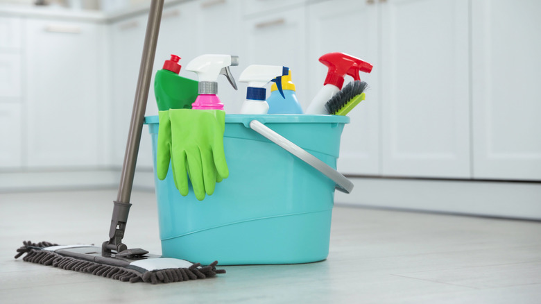 A mop and bucket full of cleaning supplies