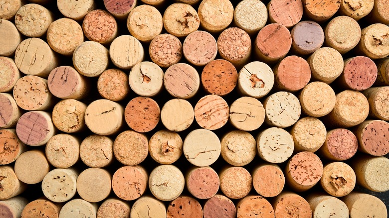 Several used wine corks are bunched together