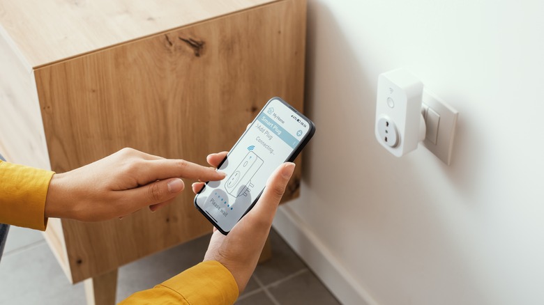 person setting up smart plug