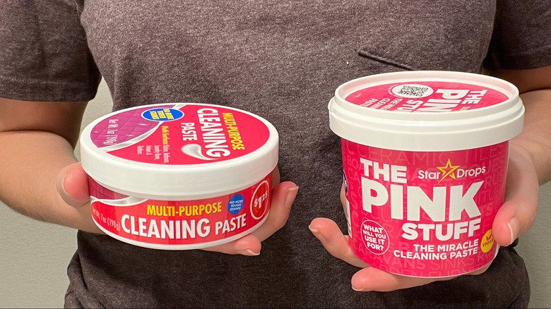 Hands holding cleaning paste products