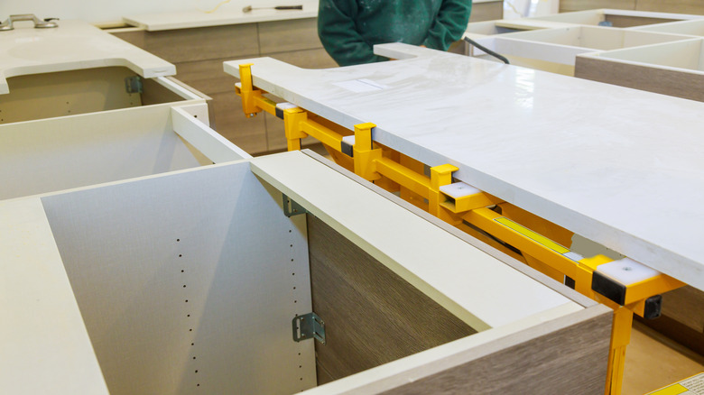 person installing granite countertops