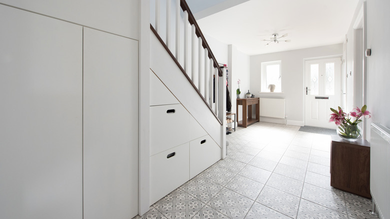 A bright front hall with patterned tile floors