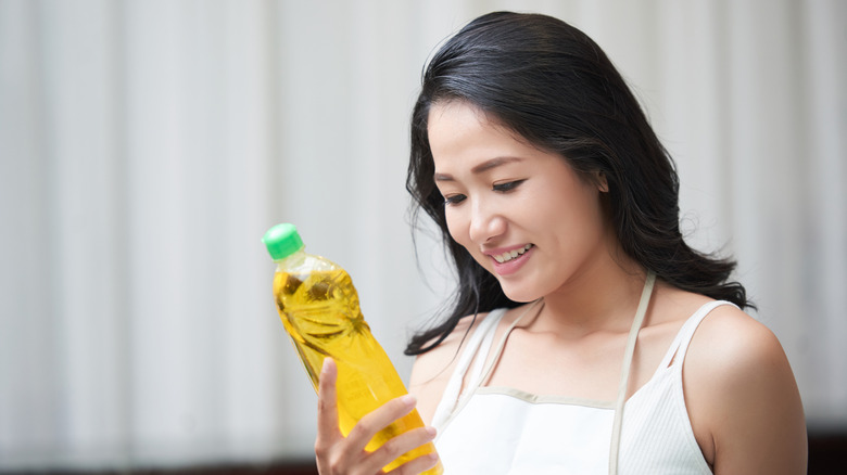 woman reading cleaning product label