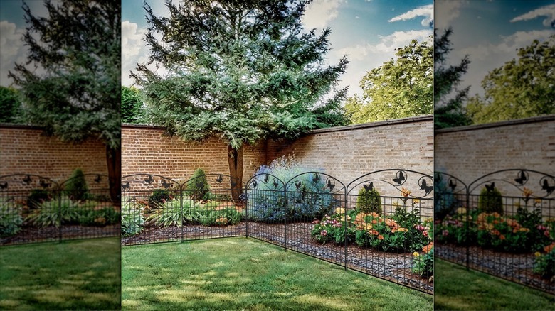 A decorative no-dig fence is installed around a flower bed