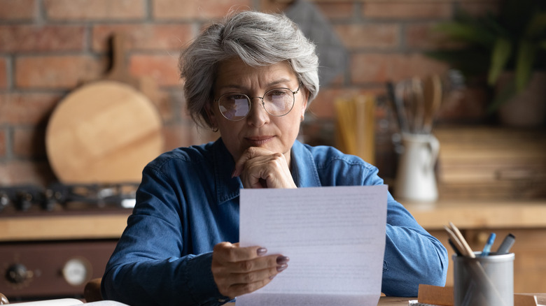 woman reading paper