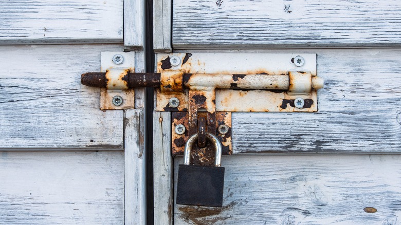 Gate latch with rust and flaking paint