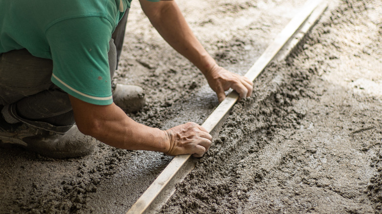 man smoothing concrete