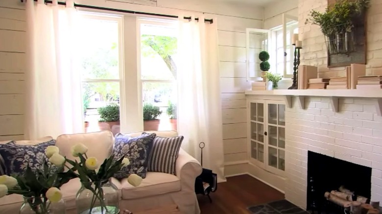 white room with brick fireplace