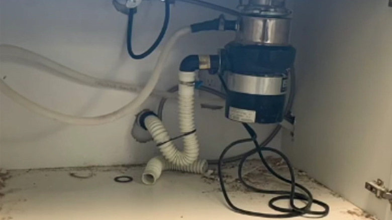 messy plumbing in cabinet