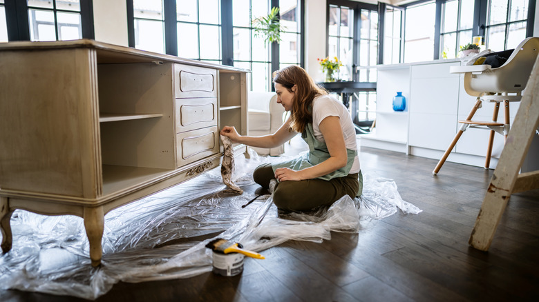 Woman paints furniture 