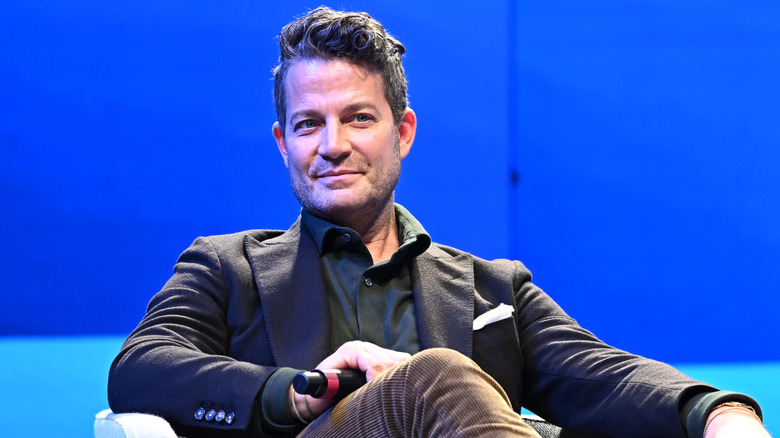 Nate berkus sitting against a blue background