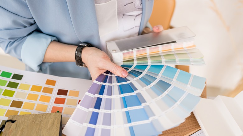 Woman examining paint samples