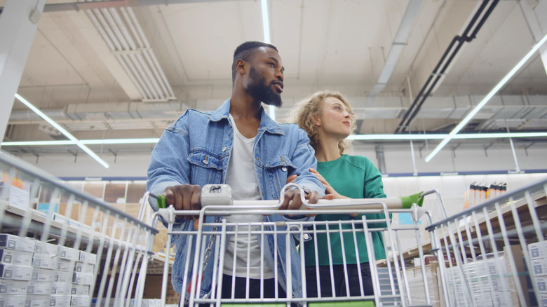 Couple walking with shopping cart