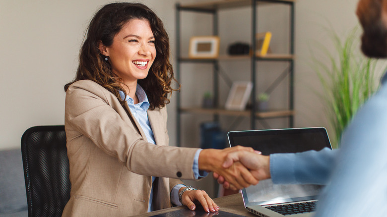 woman smiling and shaking hands