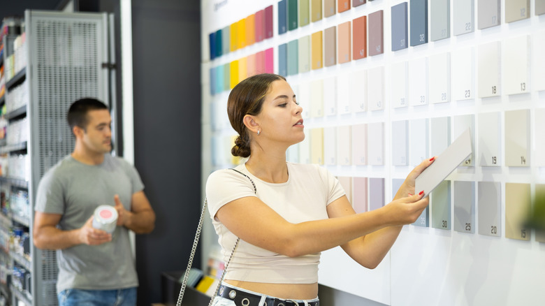 Woman looking at various paint swatches