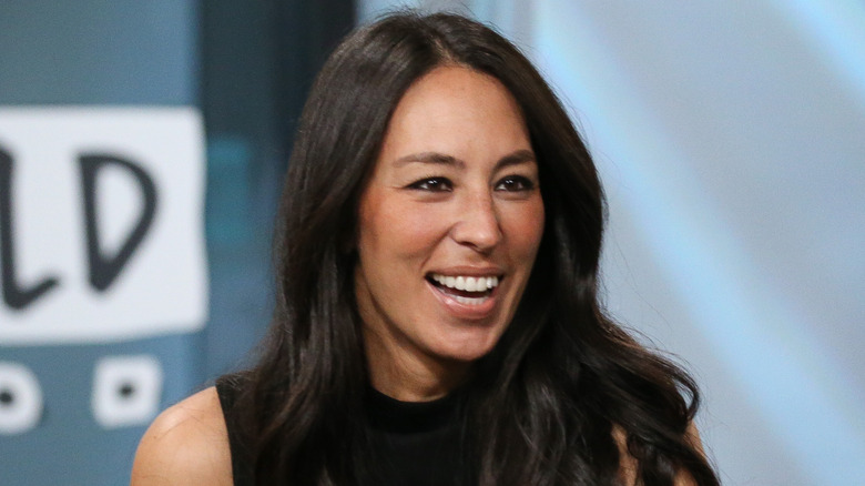 Joanna Gaines smiling and wearing black top