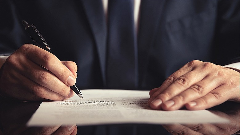 Person reviewing law with pen