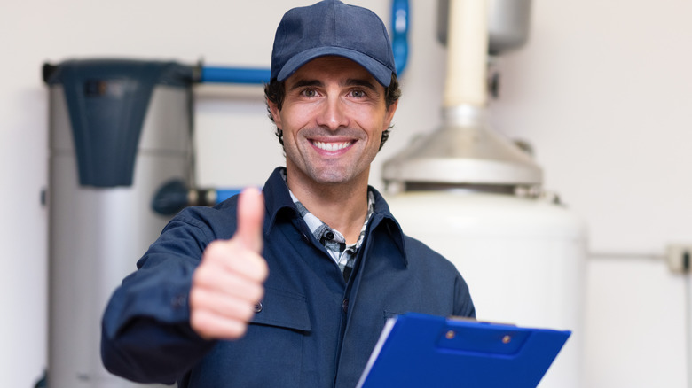 water heater technician gives thumbs up