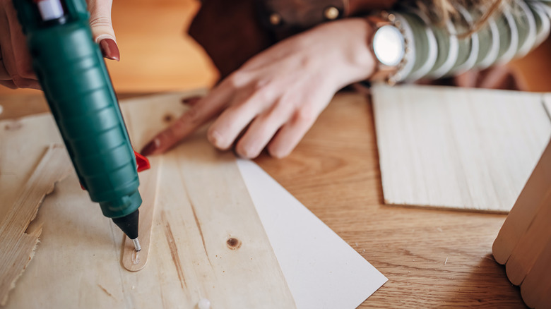 Woman using a glue dispenser