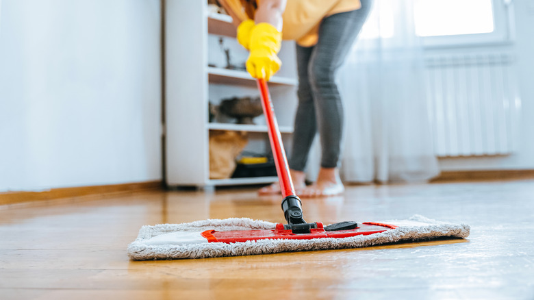 Person mopping hardwood floor