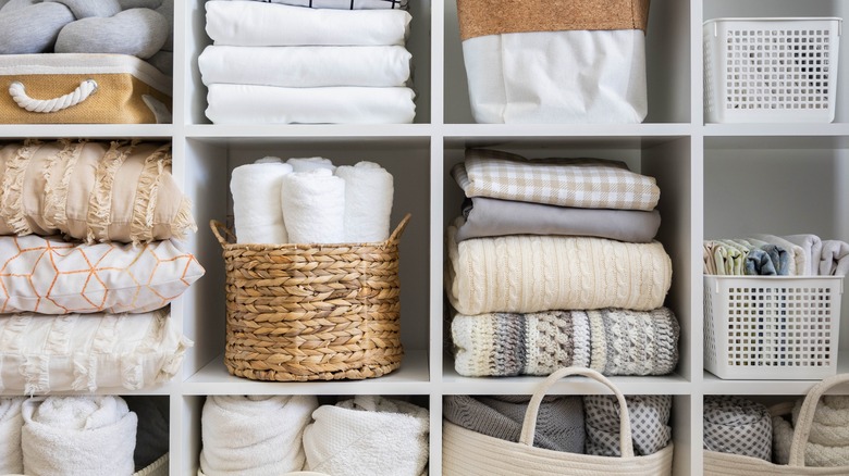 Interior linen closet with baskets and pillows