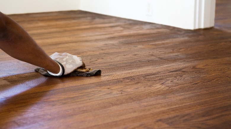 Person refinishing wood surface