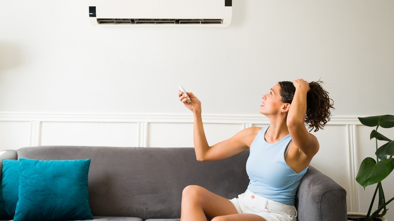 woman operating home ac system