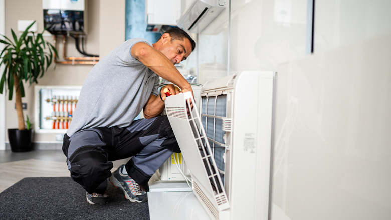 technician cleaning out ac filter