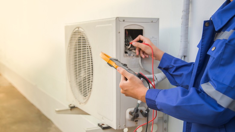 Person repairing AC unit