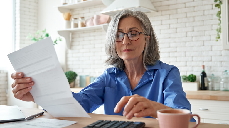 Woman reading over her bill