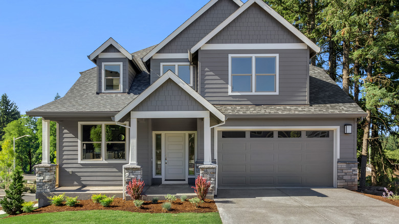 gray house with manicured lawn